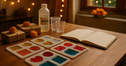 Organised home resin craft workspace with festive season bulk order production setup showing silicone moulds, finished resin gifts, and production planning notebook