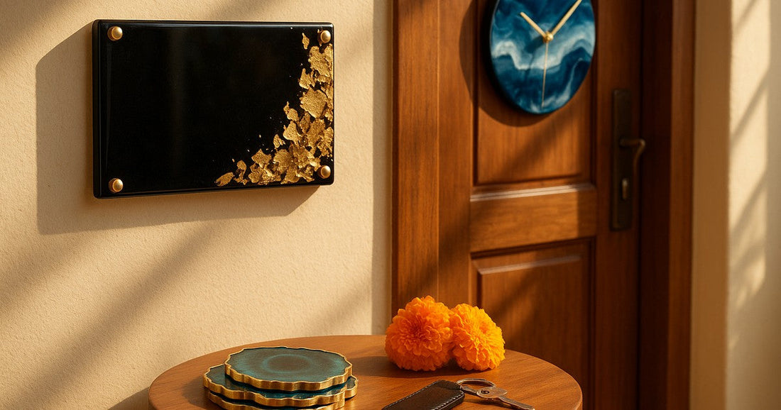 Personalized resin housewarming gifts including a custom nameplate, wall clock, and coaster set displayed in a warm Indian home entrance