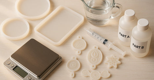 Silicone resin moulds with measuring tools including a digital scale, syringe, and epoxy resin bottles on a craft table