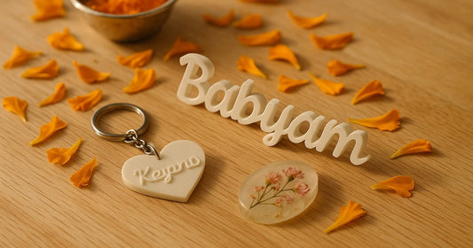 Personalized 3D printed name keepsakes and resin art gifts arranged as mundan ceremony gift ideas on a warm wooden surface with marigold petals