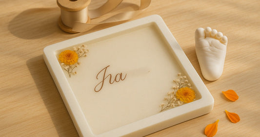 Personalized baby frame gift for newborn with resin details and baby footprint mould on a wooden surface