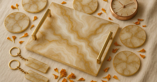 Personalized resin wedding gifts including a custom marble tray, coasters, name keychains, and a resin clock arranged on a cream linen surface with dried flowers