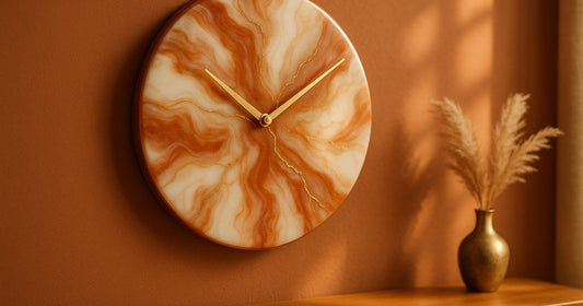 Handmade 12-inch resin wall clock with terracotta and gold colour palette hanging in an Indian living room