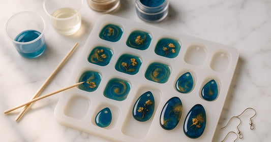 12-in-1 silicone resin jewelry mould filled with colourful epoxy resin pendants and finished pieces on a marble surface