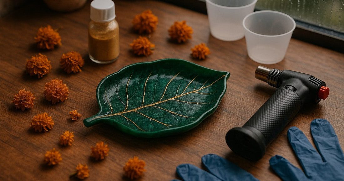 Finished resin leaf tray in emerald green and gold on a craft table with pigments and tools