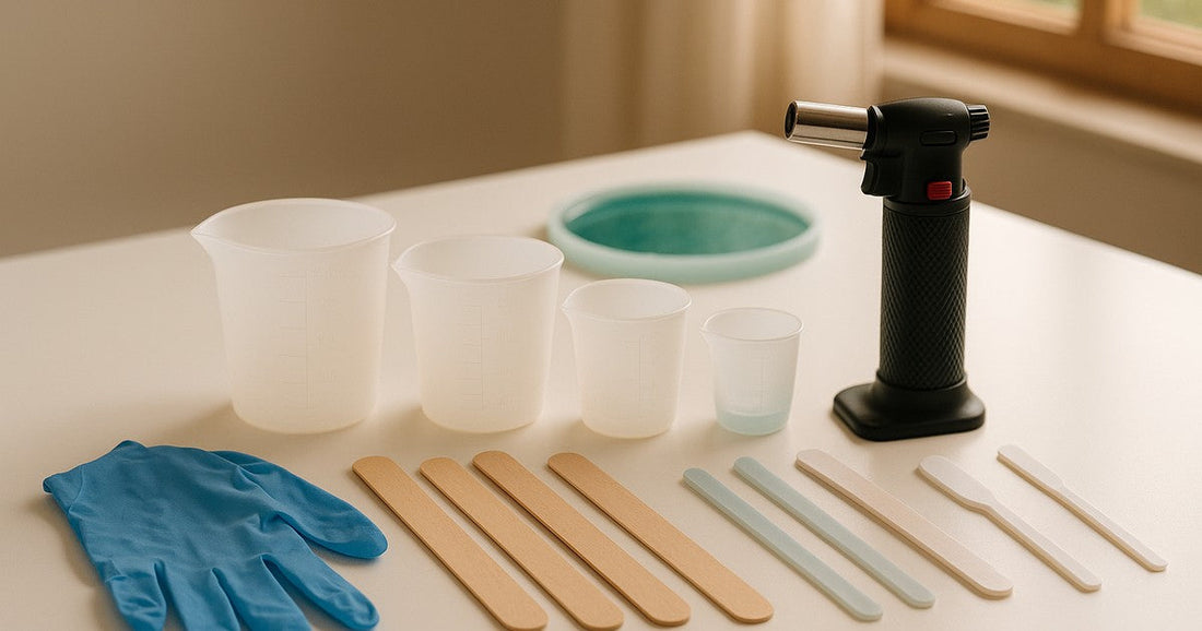 Resin mixing tools laid out on a craft workspace in India — silicone cups, stir sticks, gloves, and a blow torch