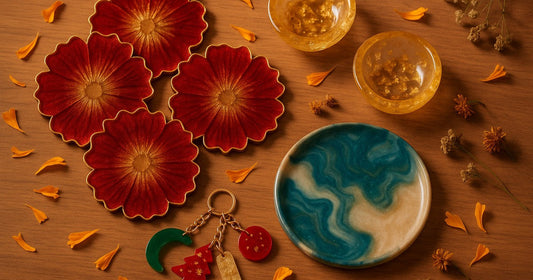 Flat lay of handmade resin products for Diwali season including coasters, diyas, decorative plate and keychains on a wooden surface