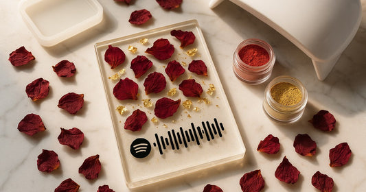 Handmade resin Spotify plaque with embedded scannable code surrounded by craft materials on marble surface