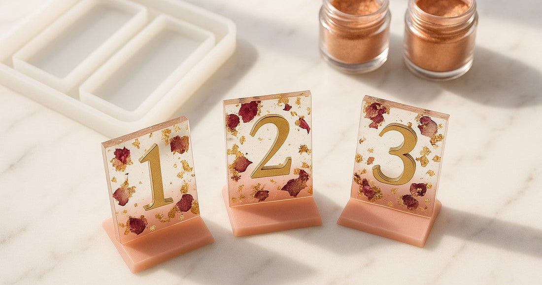 Handmade resin table numbers for wedding in blush pink and gold with dried flowers, cast using a silicone tray mould