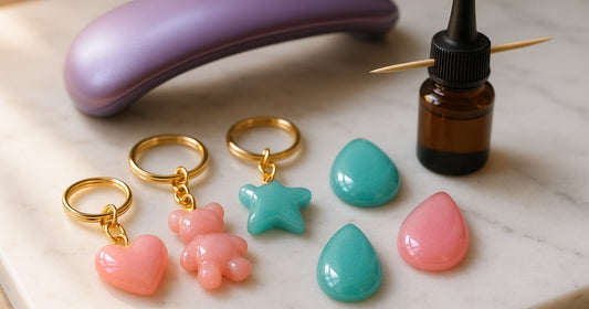 Glossy UV resin dome finish on resin keychains and pendants with UV lamp and resin bottle on marble surface