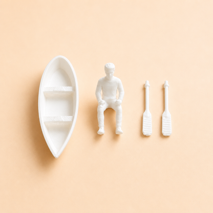 Close-up of miniature boat with man and paddles craft accessory by Shrebhavi