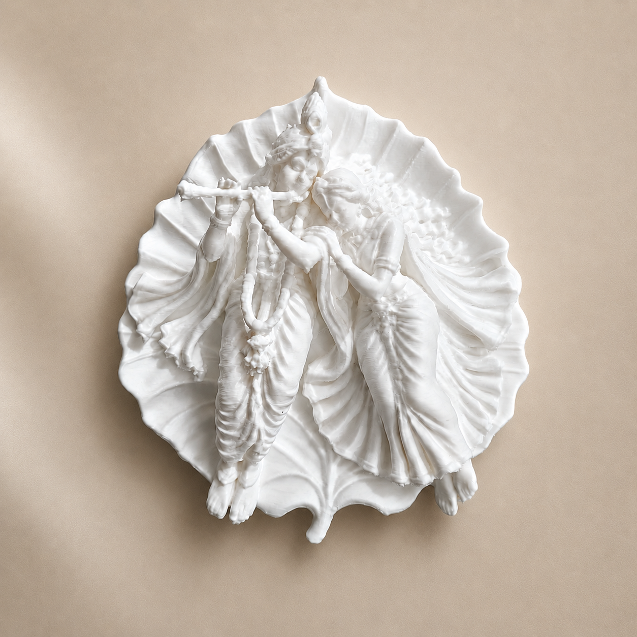 Handcrafted Radha Krishna on leaf miniature made with epoxy resin, displayed on a shelf as spiritual home decor