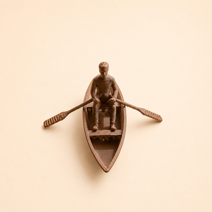 Detailed view of boat with man and paddles miniature for craft and art projects