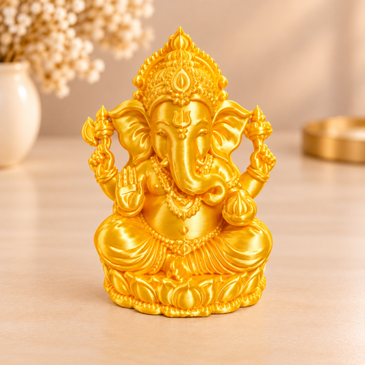 Golden Ganesha 3D printed miniature figurine in silk gold PLA with satin finish, displayed on a wooden surface