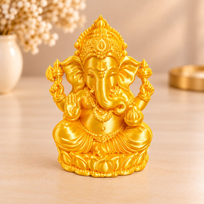 Golden Ganesha 3D printed miniature figurine in silk gold PLA with satin finish, displayed on a wooden surface